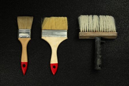 Paint brushes on a black background, top view, flat lay.の写真素材