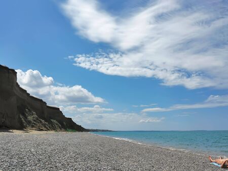 A woman lights up a deserted beach in the Crimeaの写真素材