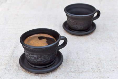 A cup of coffee on a linen tableclothの写真素材