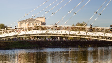city skyline suspension bridge over the river in a big city,this is one of the city's attractionsの写真素材