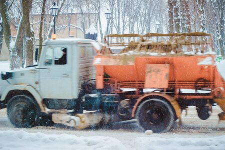on the streets in winter dropped a lot of snow so employ here are snow machinesの写真素材