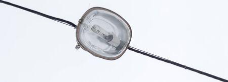 lantern on a wire against a white winter sky, a device for lighting