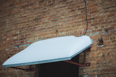 visor building covered with white snow, cityscape