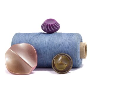 Different buttons bright and beautiful on a reel of thread