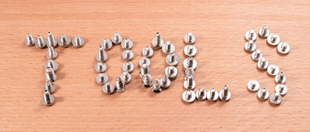 word tools laid out on a wooden background, the topic is always relevantの写真素材