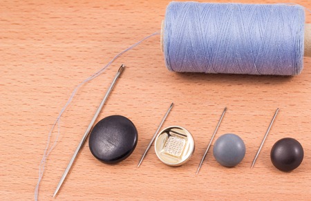 accessories for the textile industry with a needle and thread to sew buttons
