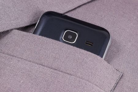 mobile camera looks out of his jacket pocket is a business styleの写真素材