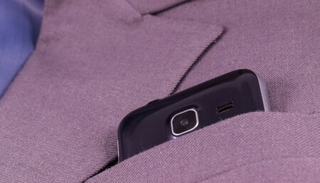 mobile camera looks out of his jacket pocket is a business styleの写真素材
