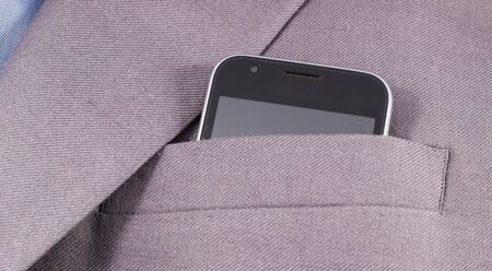 mobile looks out of his jacket pocket is a business styleの写真素材
