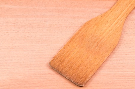 wooden spoon for cooking on a wooden background, very useful, so as not to scratch the coating metal cookwareの写真素材