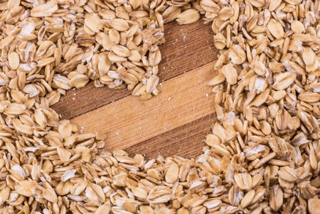 oatmeal and a heart on a wooden background, food that adore athletesの写真素材