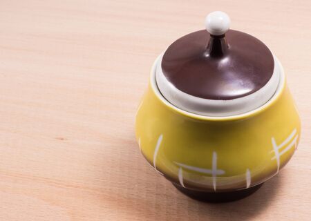 jug of sugar on a wooden background, very beautiful, small sizeの写真素材