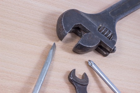 screwdriver on a wooden background, it is a tool for screwing and unscrewing screws