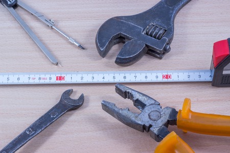 wrench on a wooden background, tool for loosening nuts and boltsの写真素材
