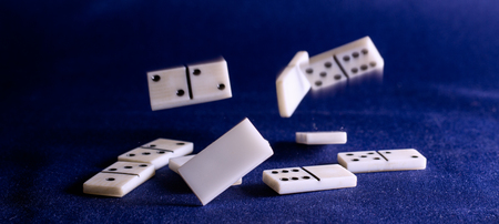 dominoes on the background of the fabric is very popular all over the world board game, its purpose to the hands of the player there is not one diceの写真素材