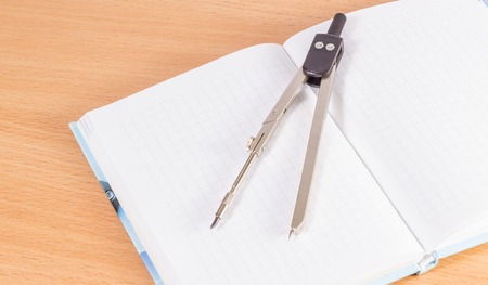 The compass on an open notepad is a drawing tool, using this tool draw a circleの写真素材