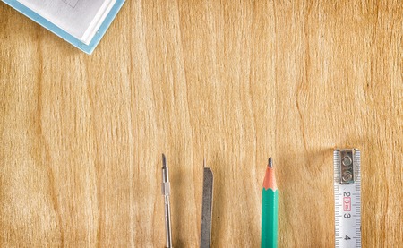 Tools for drawing and measuring on a wooden backgroundの写真素材