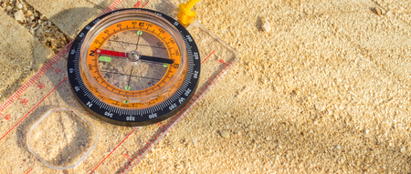 Compass on the stump, this device allows you to navigate in an unfamiliar terrain, its arrow always points to the north, this allows you to choose the right direction in the hike to the exampleの写真素材