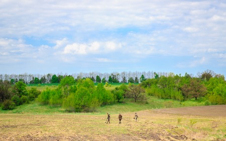 Three in young men on the field, their hobbies search for vintage metals hidden undergroundの写真素材