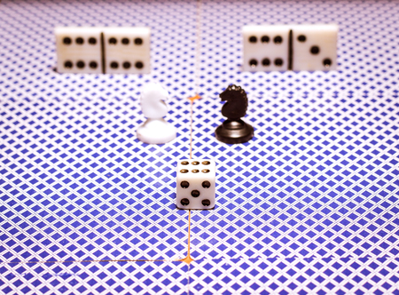 Chess dice and dominoes on the back of playing cards