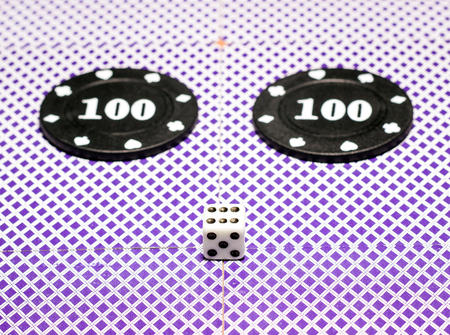 Dice and poker chips on the back of playing cards objects for popular board games