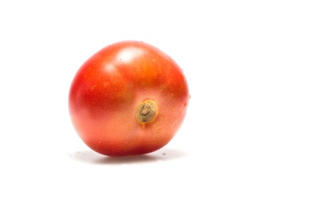 light red tomato on white background healthy agricultureの写真素材