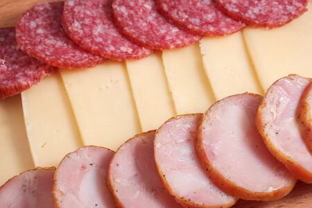 appetizing pieces of smoked and homemade chicken sausage and cheeseの写真素材