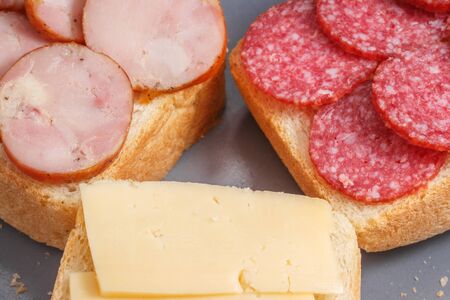 three sandwiches with sausage and cheese closeup looks appetizing