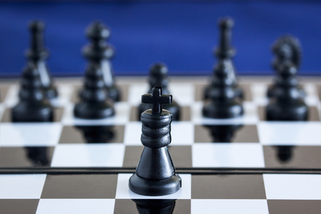 black chess king on the background of his army he is the main figure on the boardの写真素材