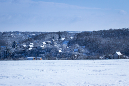 Village in winter behind a snowy desert under a dark blue sky is clean and no one around is very beautifulの写真素材