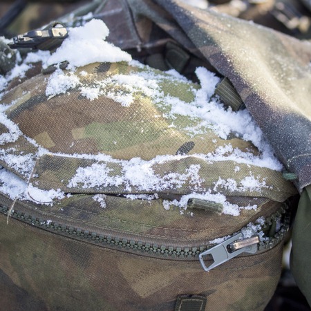 snow on a pocket of a military backpack closeupの写真素材