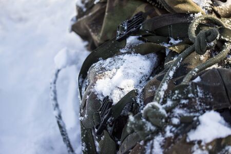 bright white snow covered military backpack concept of tourism in the cold seasonの写真素材