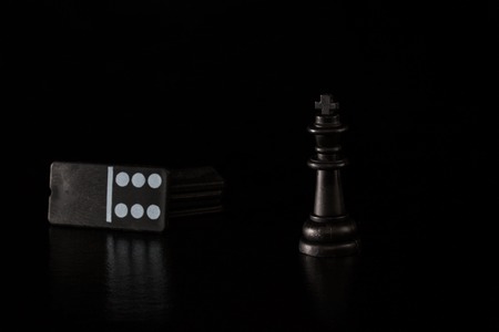 chess king and dice dominoes on a dark background concept of popular board games around the worldの写真素材