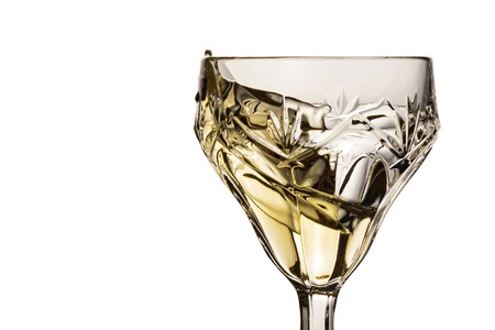 splash of white wine in a vintage glass a bright and appetizing alcoholic drink made from grapesの写真素材