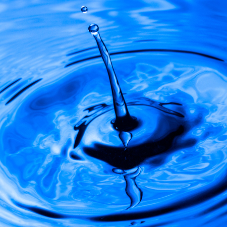 beautiful drop of dark blue water closeup of an exciting splash concept of nature and the environmentの写真素材