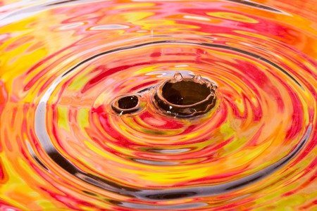 bright autumn abstraction on the surface of the water exciting drops close up and reflection of the leavesの写真素材