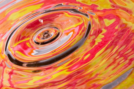 autumn drop on the water closeup fascinating abstraction conveys the beauty of the seasonの写真素材