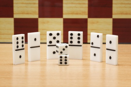 Dice and dominoes on the background of a chess board concept of board games