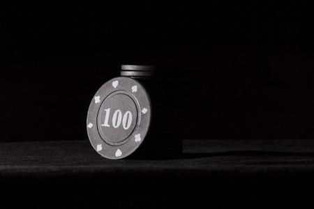 bright black poker chips on a dark background shiny casino concept and gambling board games