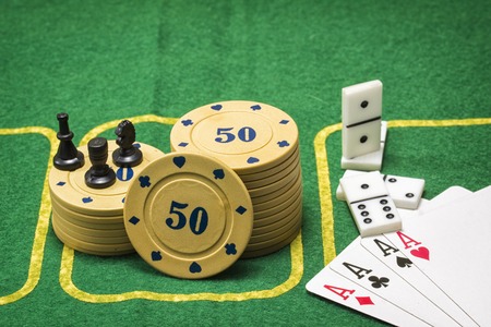 Objects for popular board games on the green poker canvasの写真素材