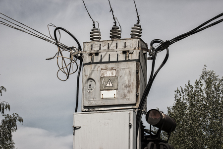 transformer cabinet on a cloudy sky background closeup sign warns caution high voltage dangerous for...