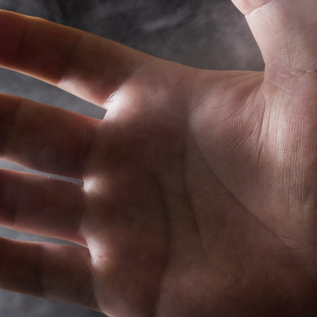 hand closeup on a gray cigarette couple background concept of smoking cessation