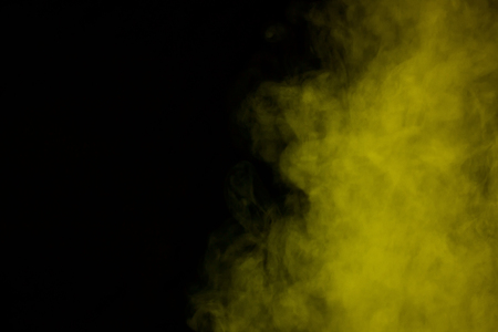 mystical yellow steam on a dark background concept of smoking and addictionの写真素材