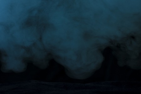 dense cloud of steam from an electronic cigarette on a dark background concept of smoking and addictionの写真素材