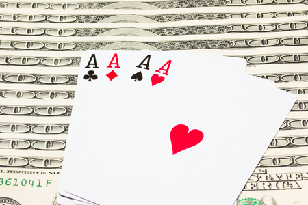 four aces against the background of many hundred dollar bills combination of success concept of winning and casinoの写真素材