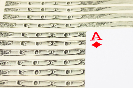 diamond ace symbol of success and many hundred dollar bills closeup concept of business and gambling