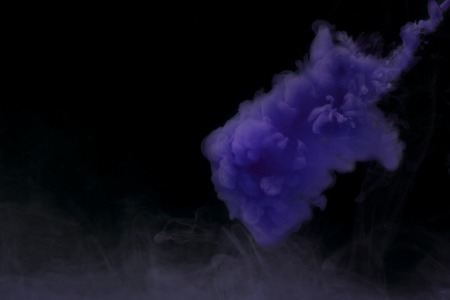 mysterious abstraction blue watercolor sprayed over cigarette smoke mystical abstraction on a dark backgroundの写真素材
