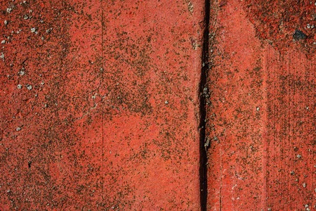 bright red brick texture with a crack close-up industrial background for design concept of building materialsの写真素材
