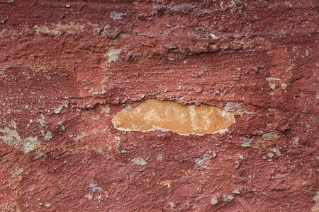 bright texture of red concrete wall with ripped plaster of grunge background for designの写真素材