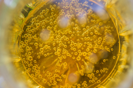 exciting abstraction of a carbonated alcoholic beverage light beer in a glass top viewの写真素材